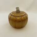 Gold glitter resin pumpkin trinket box with lid on, pale cream background