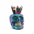 Resin skull makeup brush holder - vivid teal purple iridescent finish on white background